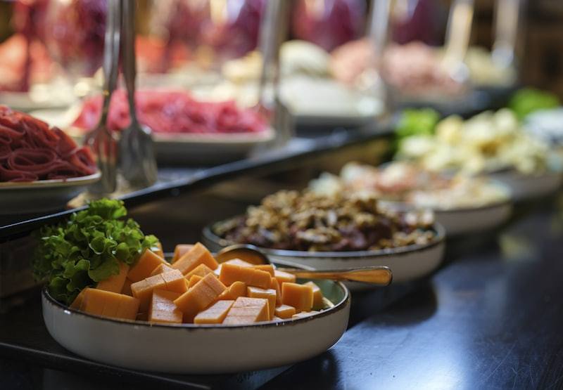 breakfast buffet table filled with assorted food items