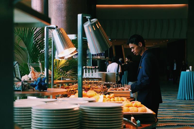 guest selecting food at buffet table in hotel restaurant