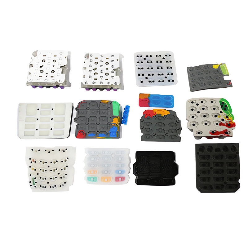 Underside of a conductive silicone keypad showing molded carbon pills