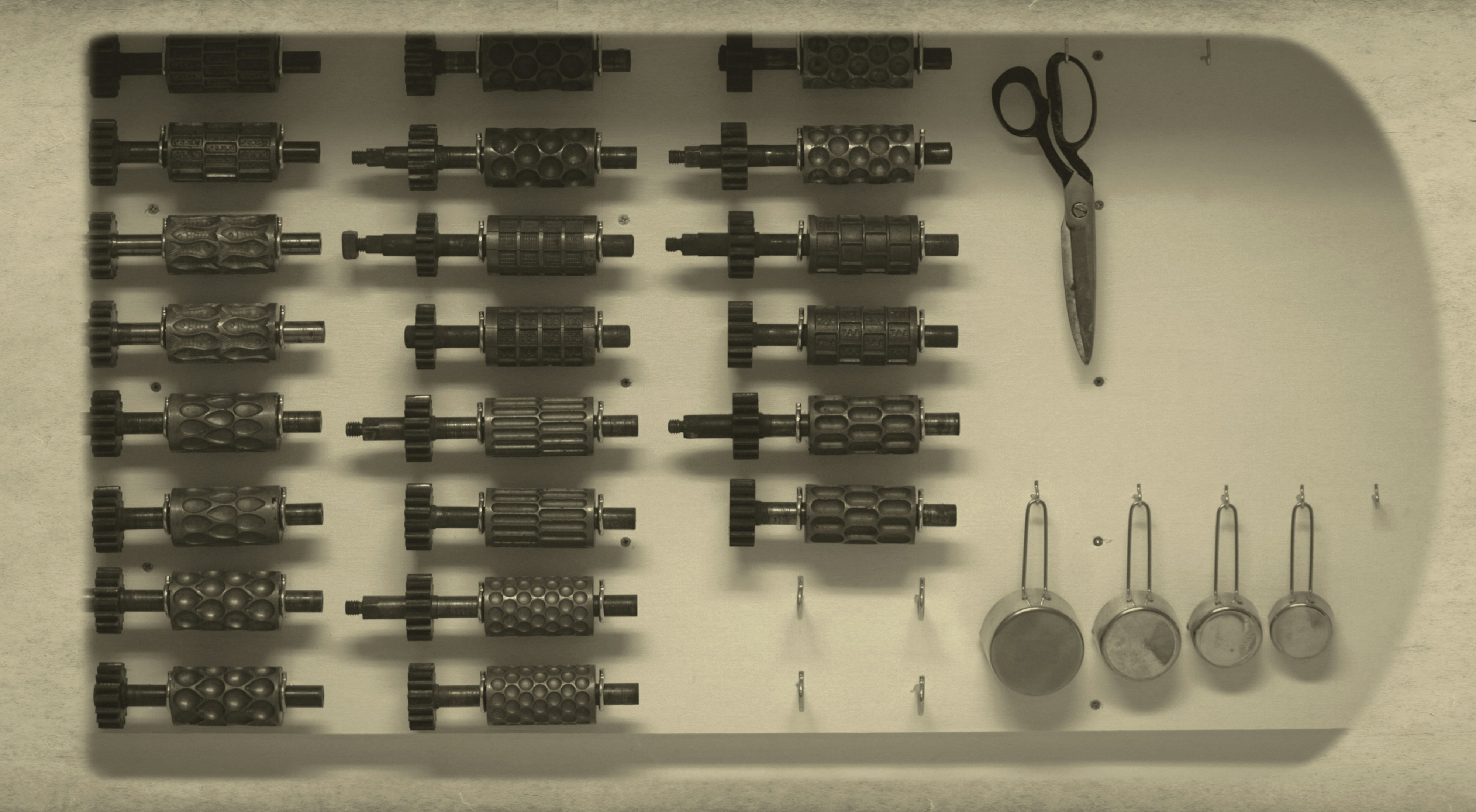 A collection of insert molded products like a screwdriver and a knob with a metal thread