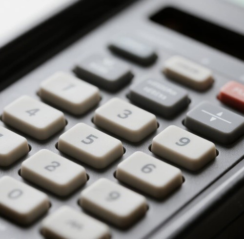What is the typical shrinkage rate of a molded silicone keypad, and how should I account for it in panel design?