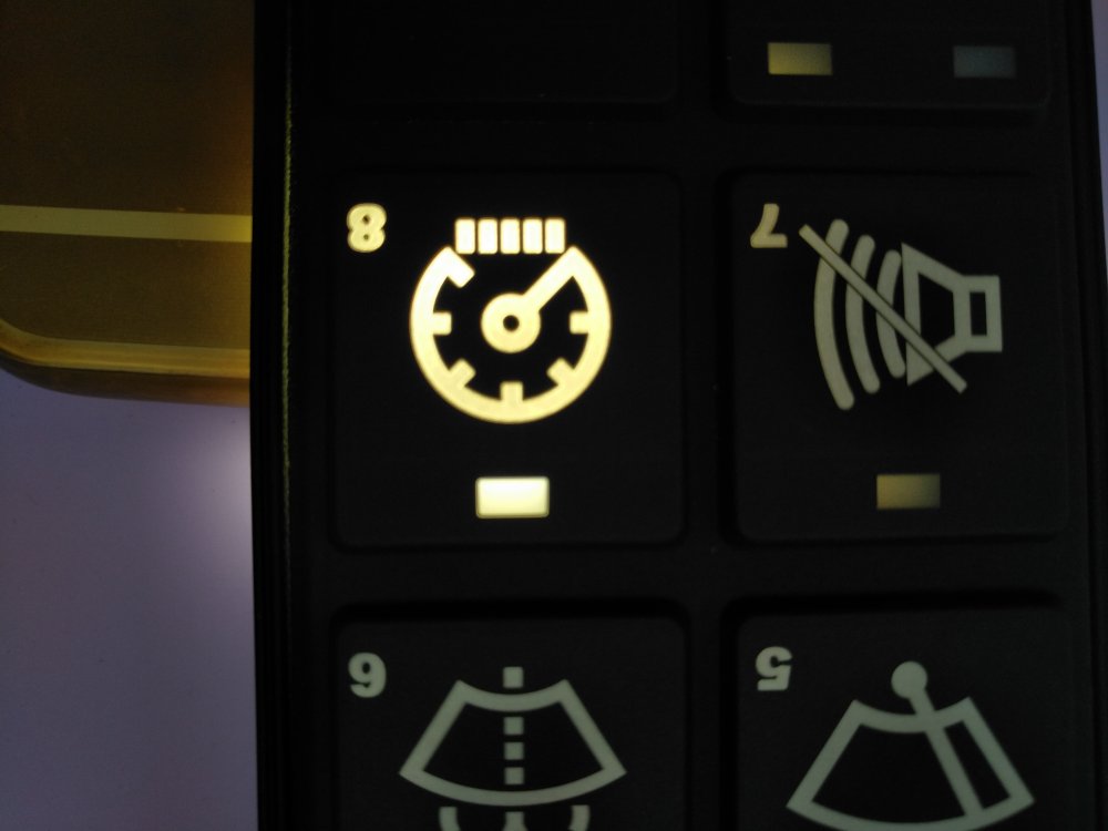 Backlit custom silicone rubber keypad with laser-etched icons on dark surface for industrial control panel