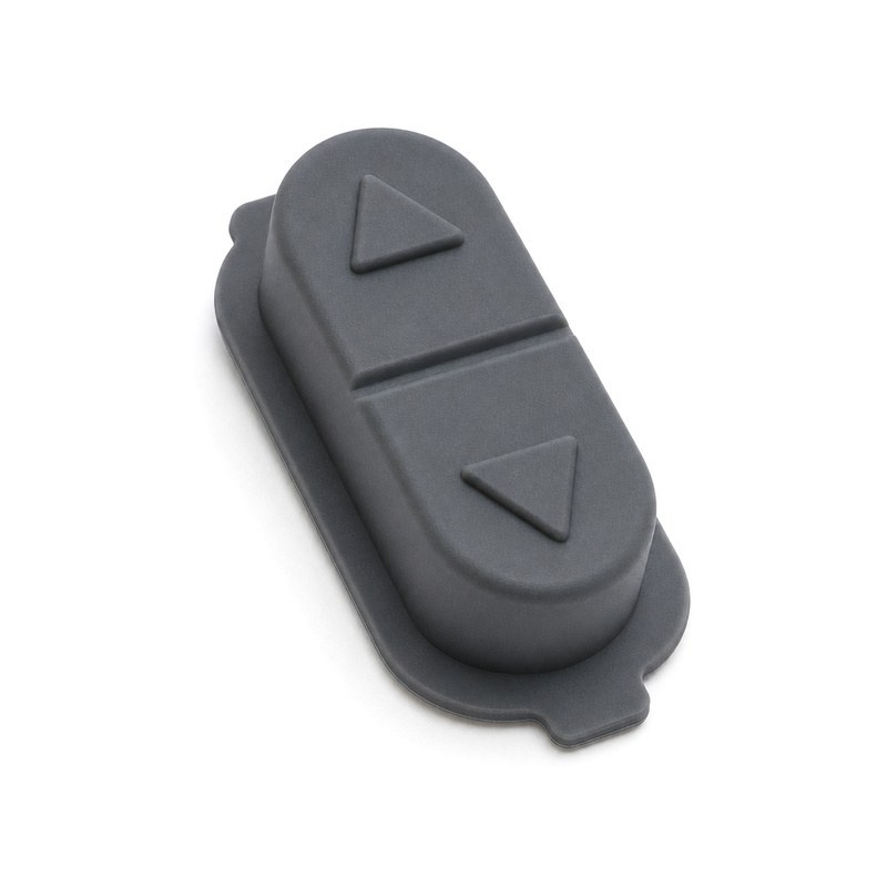 Molded silicone rocker key with up and down actuation symbols and a flat sealing flange for a machine control panel