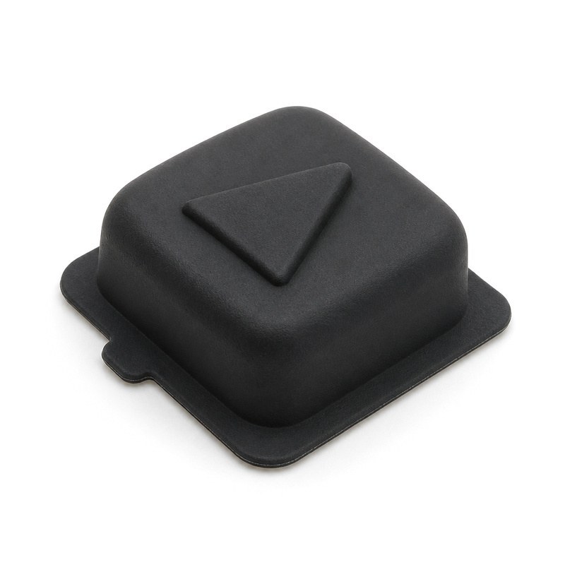 Single molded silicone rubber key with an embossed arrow symbol and a flat sealing flange with a locating tab