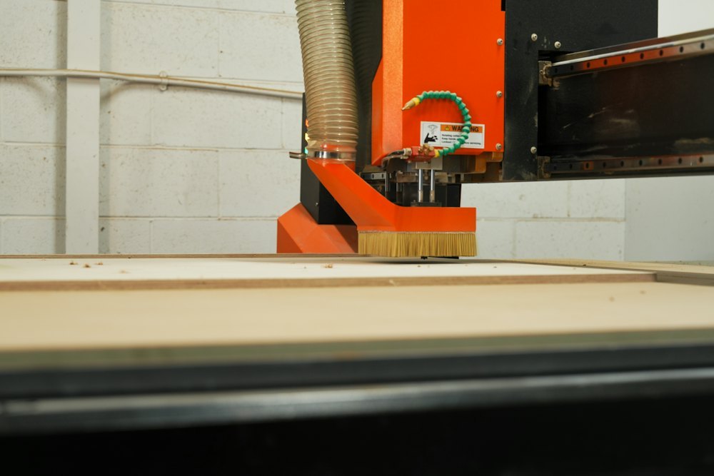 CNC machine cutting a metal mold in a tooling workshop