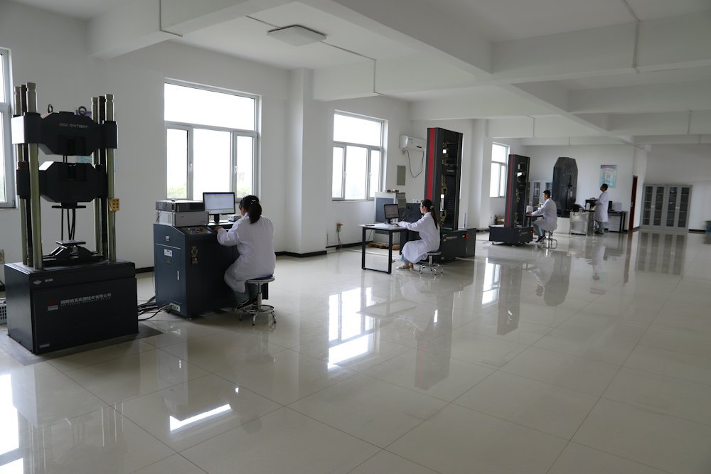 Quality control staff inspecting parts with testing equipment in a laboratory