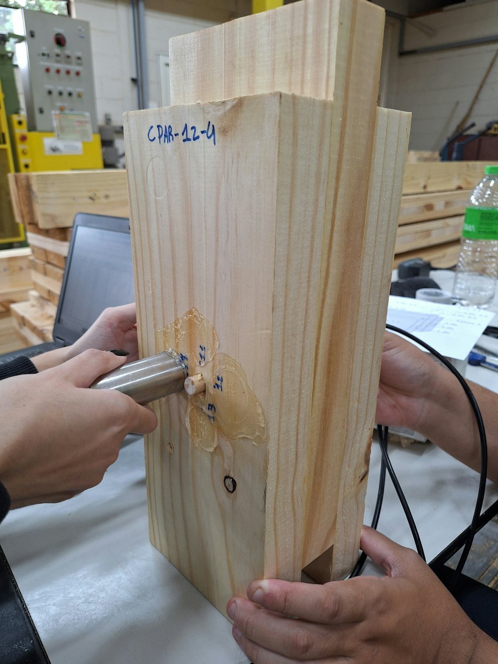 Laboratory technician testing material samples with ultrasonic equipment