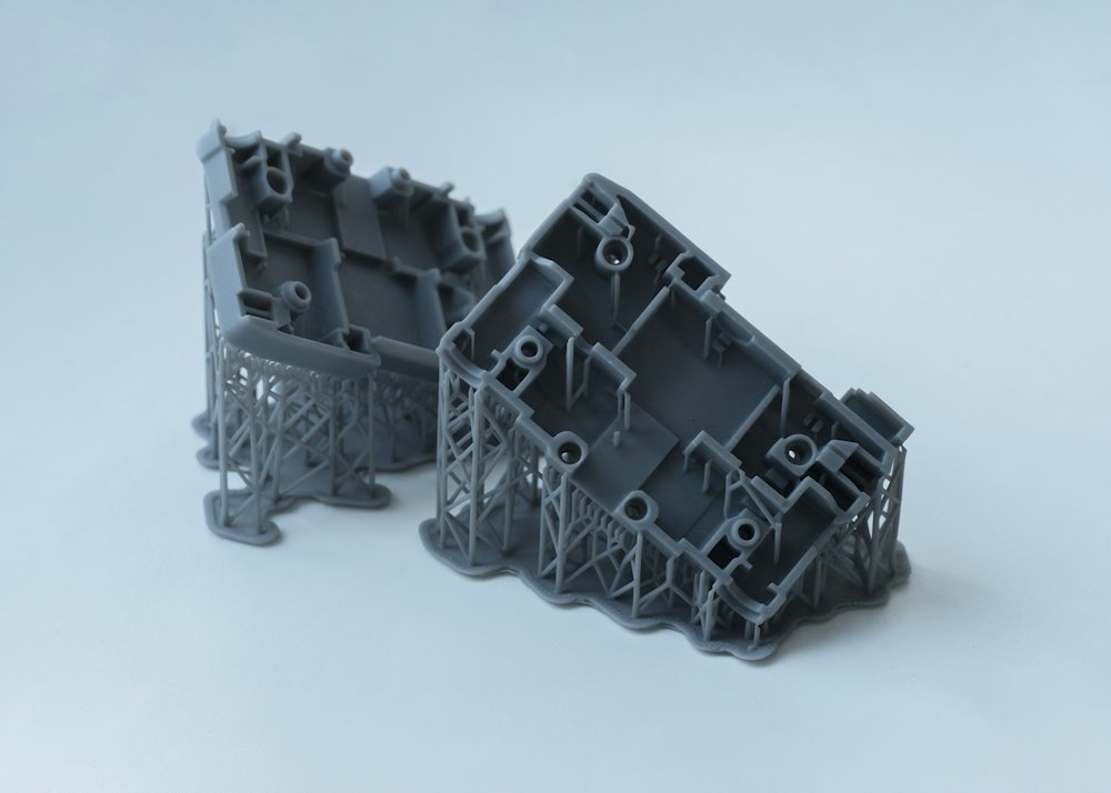 Two precision prototype parts produced from a first mold trial