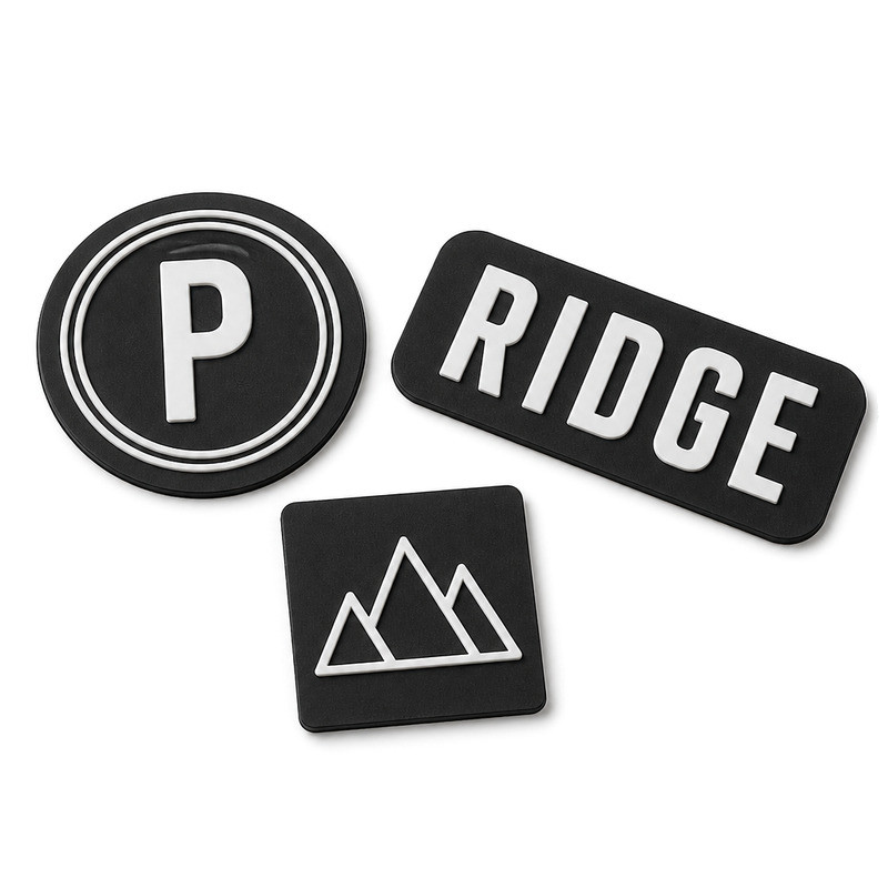 Three moulded silicone labels showing different relief levels and embossed detail
