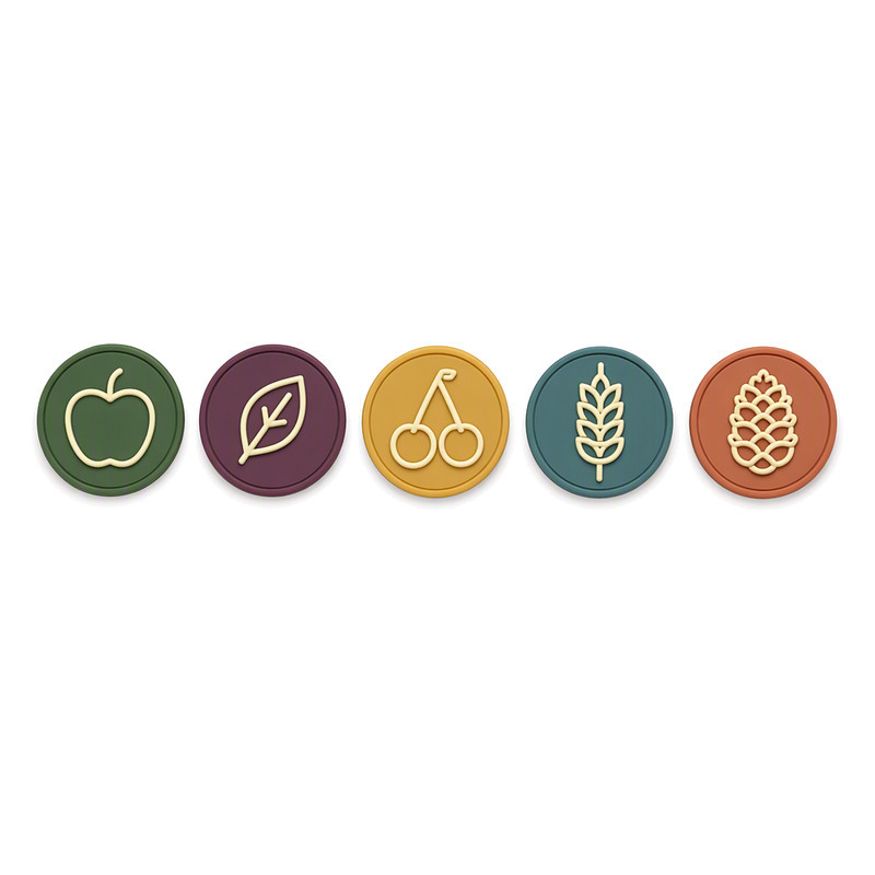 Five small round silicone labels with botanical line motifs, sized for lightweight knitted garments
