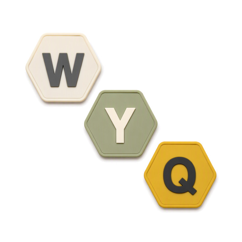 Three hexagon silicone monogram patches in different colours cascading, shown as a comparison set for batch inspection records