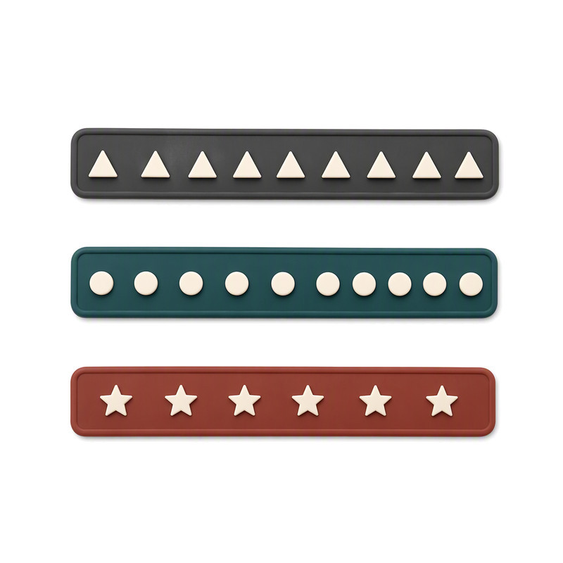 Moulded silicone trim bands with raised triangle dot and star motifs for cap tapes and trims