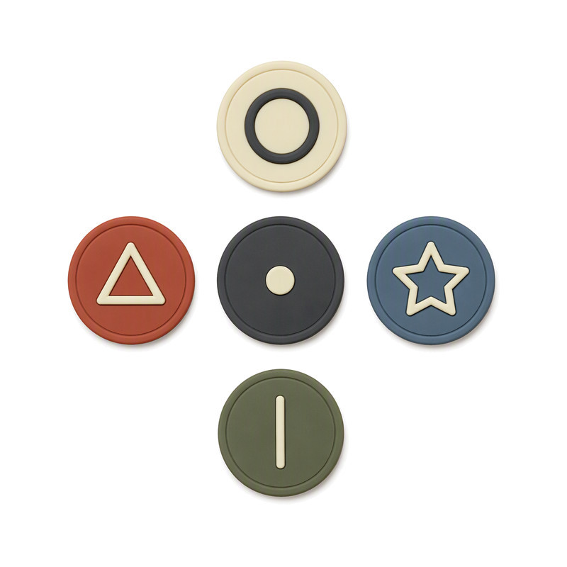 Moulded silicone backpack patches with concentric and patterned raised motifs on scalloped square labels