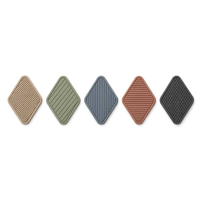 Moulded silicone bag patch collection with raised diagonal rib textures on diamond-shaped labels