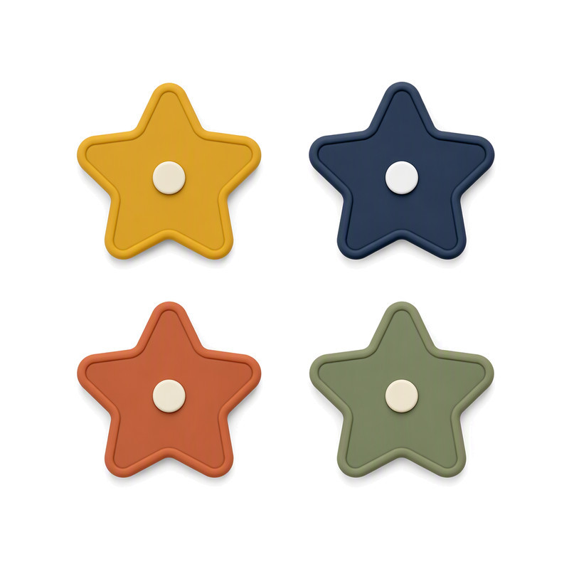 Custom silicone patches in star shapes with raised borders and a central insert, moulded in four colours for apparel branding