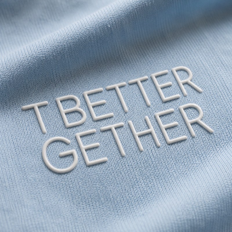 white raised silicone heat transfer lettering applied to a light blue knit uniform shirt