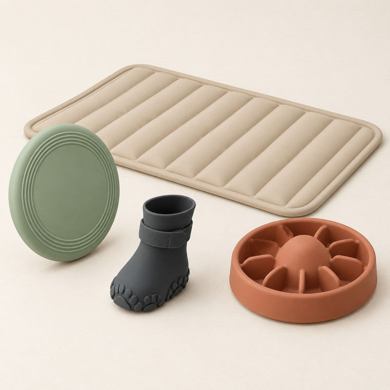 Large moulded silicone pet mat with quilted channels shown beside a slow feeder bowl and silicone paw protector boot