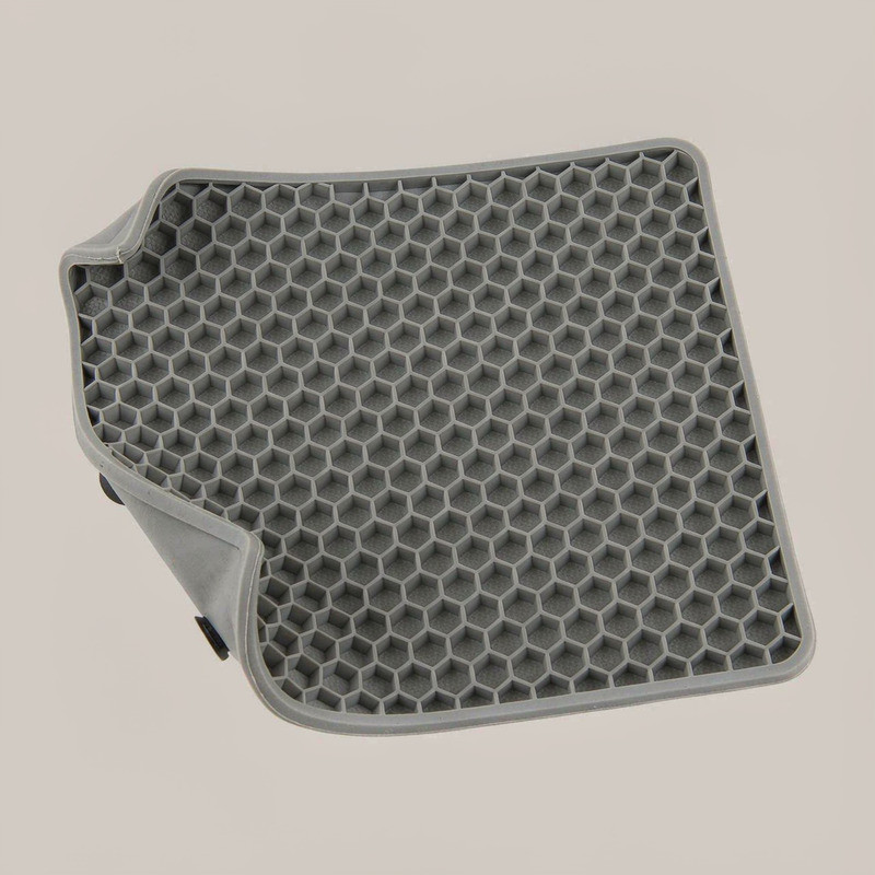 Grey silicone lick mat with a dense honeycomb texture, used to discuss narrow grooves and closely spaced ridges in mold design