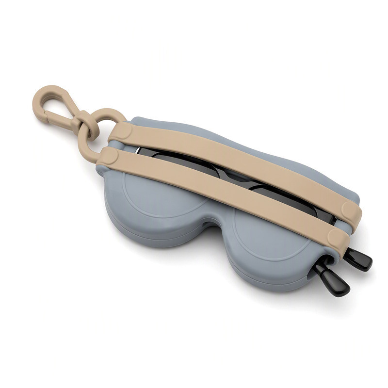 Grey silicone sunglasses holder with two tan retaining bands threaded through it