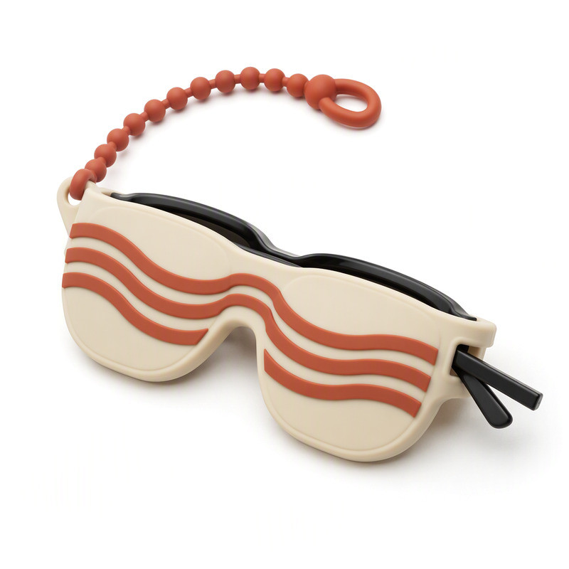 Ivory silicone sunglasses holder with coral wave relief, showing an open slot with sunglasses inserted