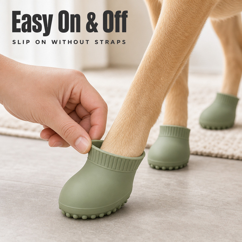 Hand sliding a silicone dog boot over a paw, showing the opening stretching around the paw