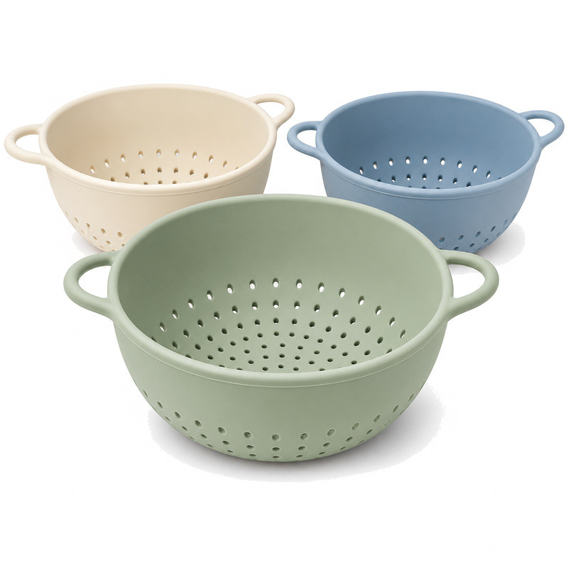 Three-quarter view of three silicone colanders showing the hole pattern across the base and lower sidewall