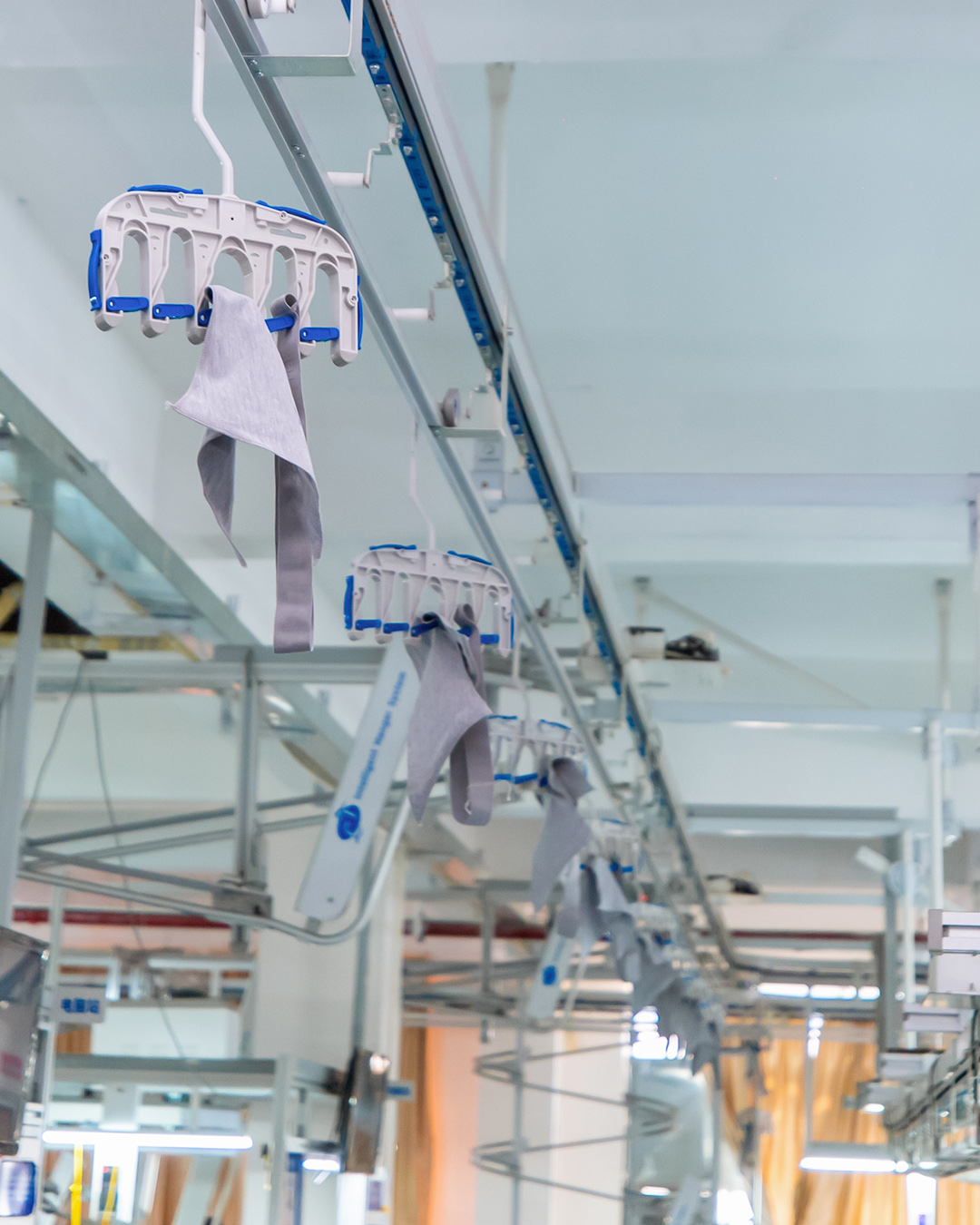 Eationwear factory floor: hanging production system running in the Dongguan plant, supporting leggings bulk capacity and line turnaround