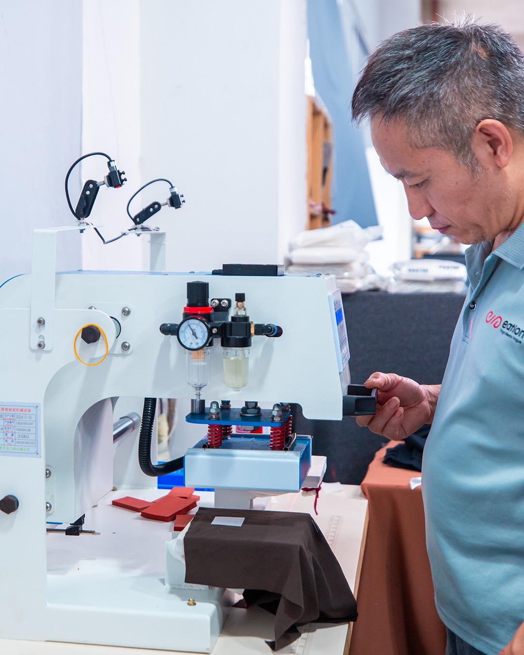 Athletic wear manufacturer heat-press station: names, numbers and logos applied with parameters matched to the fabric