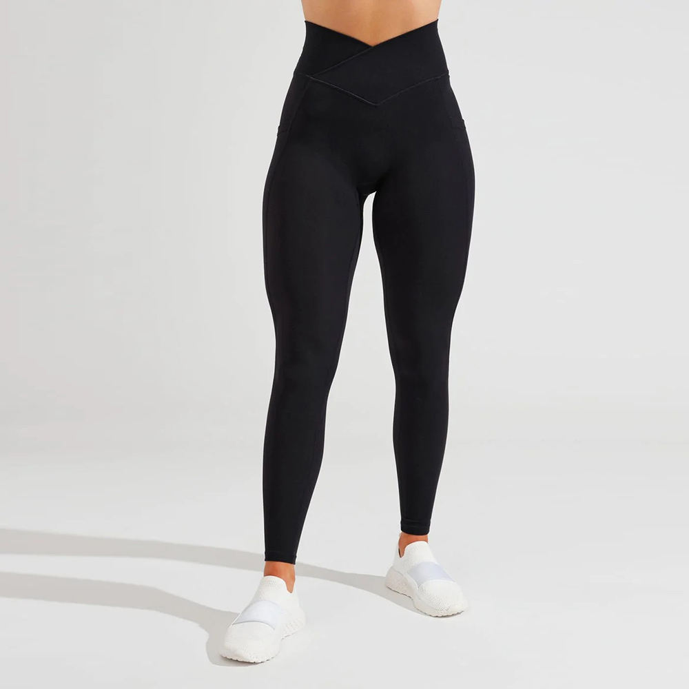 Leggings product shot: black high-waist yoga leggings with V-cross waistband, front view, used to illustrate how GSM (fabric weight) drives hand-feel, opacity, and support