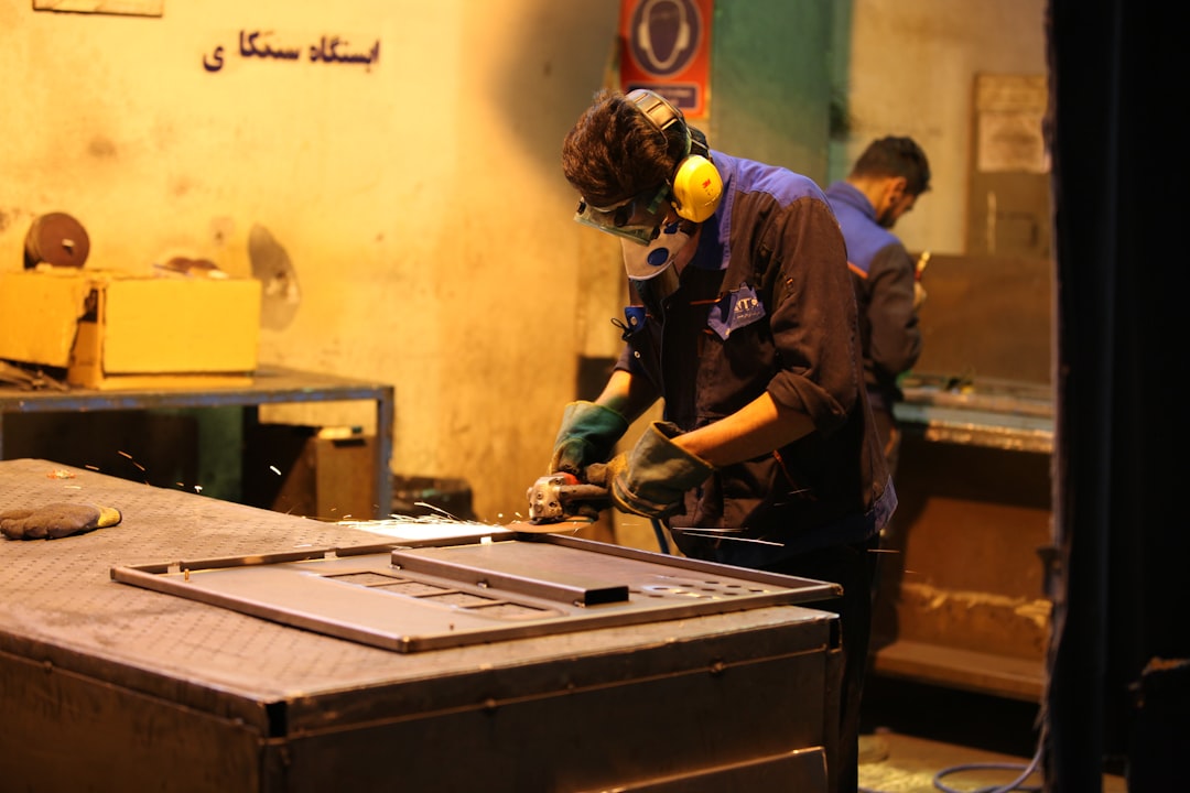 A factory worker inspecting a gas stove on the production line