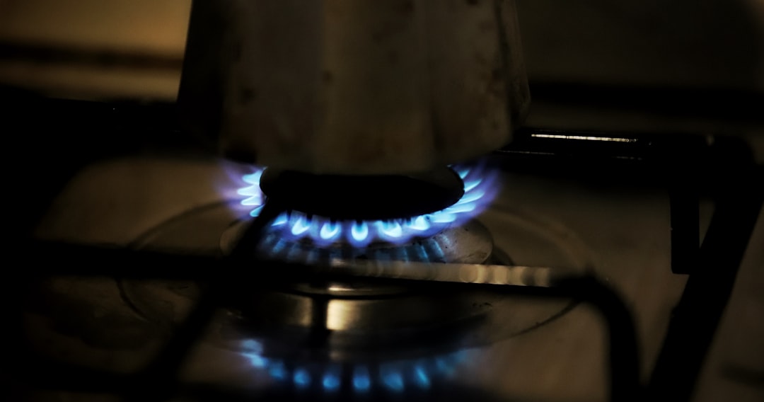 Close-up of a high-power brass burner on a gas stove