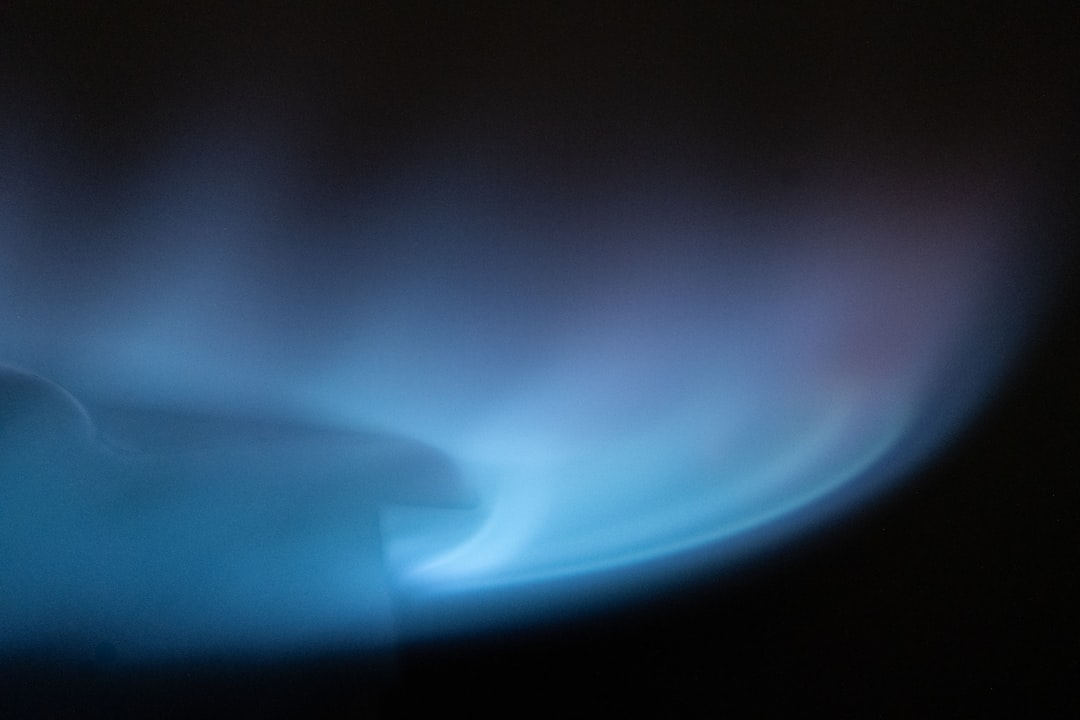Close-up of a high-efficiency gas burner with a blue flame