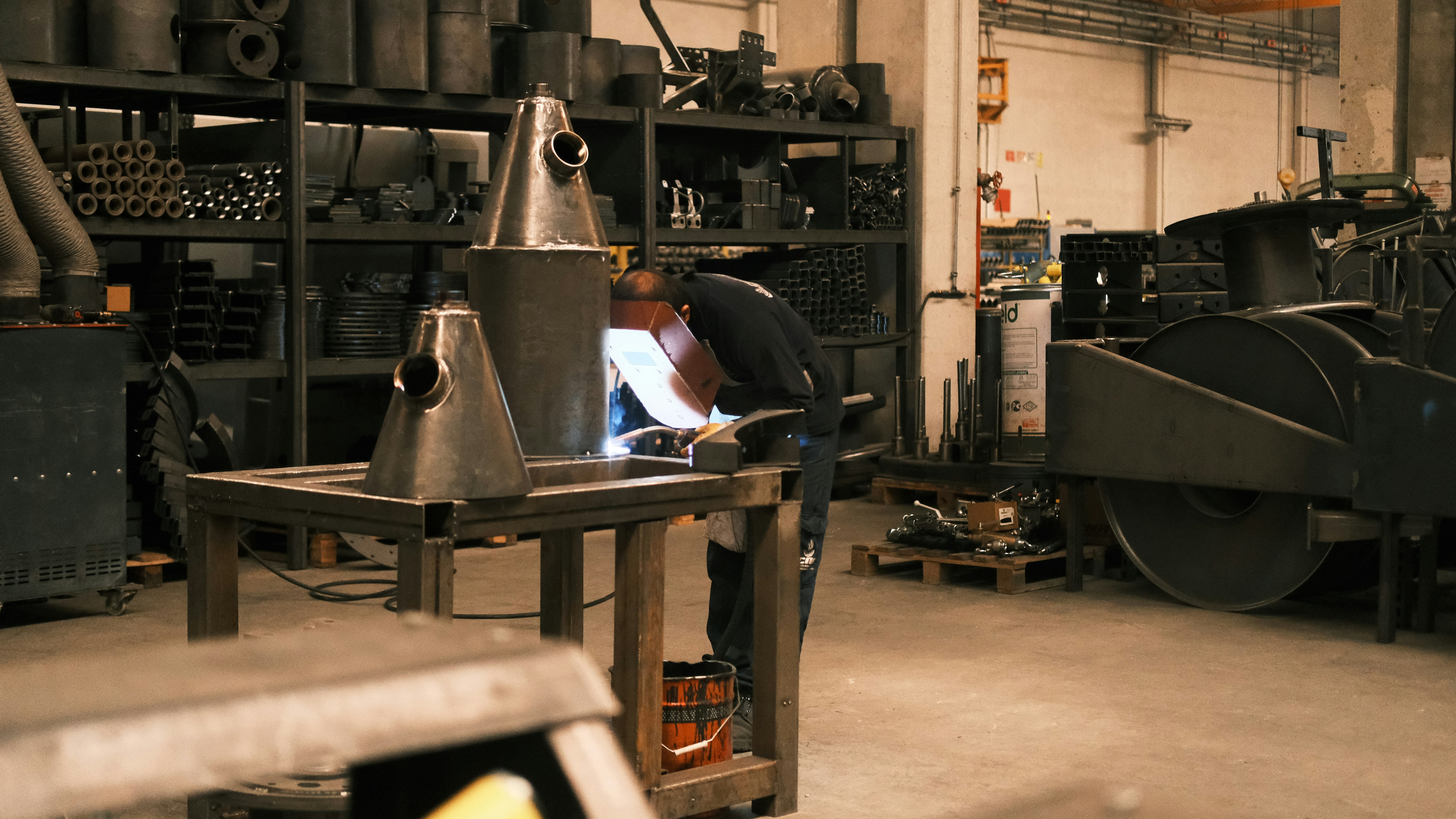 An aerospace technician inspecting a custom-fabricated aluminum wing component