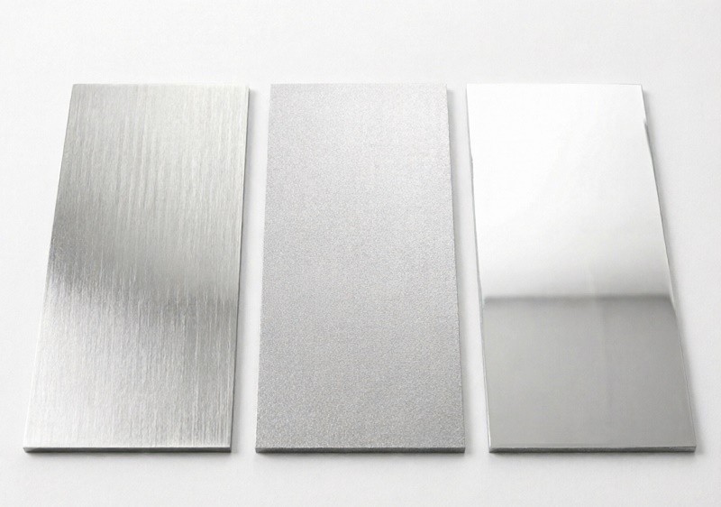 A CNC milling machine cutting an intricate design into a stainless steel block