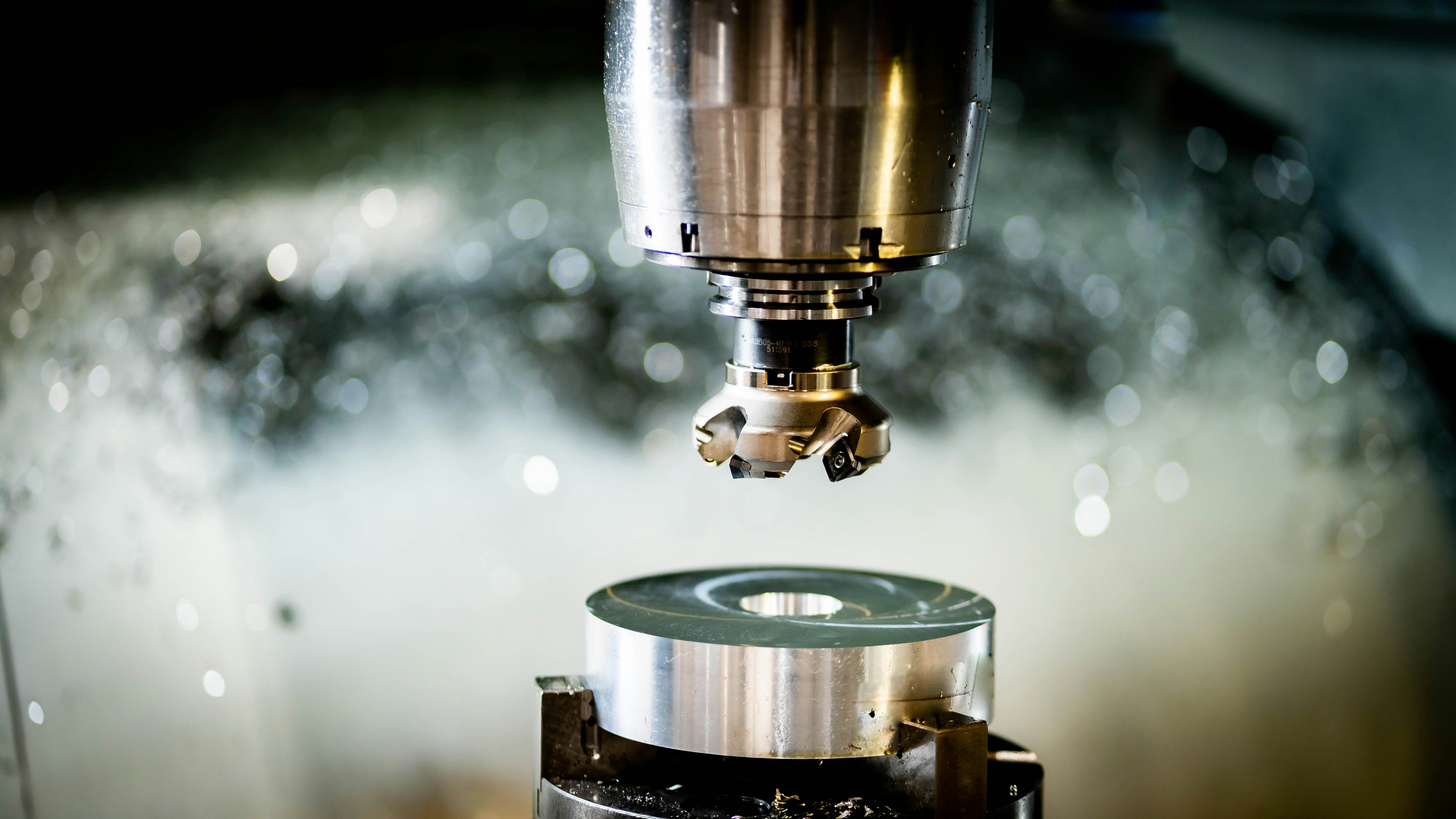 A 5-axis CNC milling machine in operation creating a complex metal part