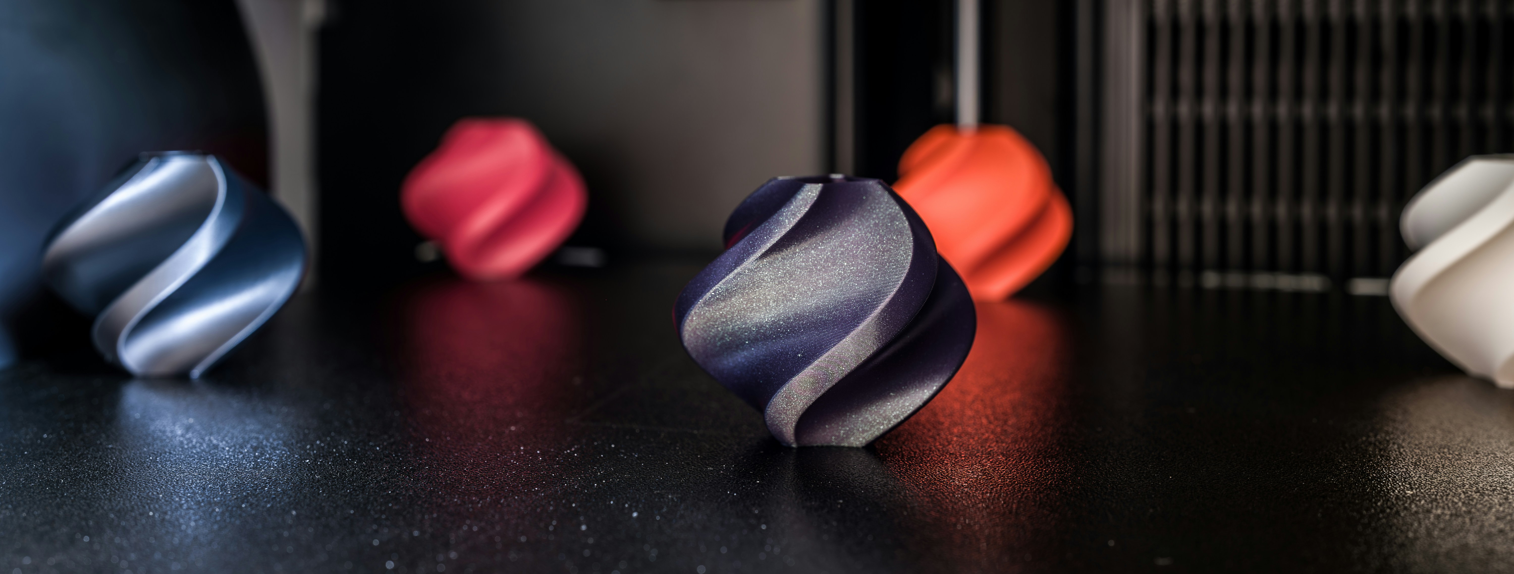 A side-by-side comparison of a colorful visual prototype and a durable functional 3D printed part.