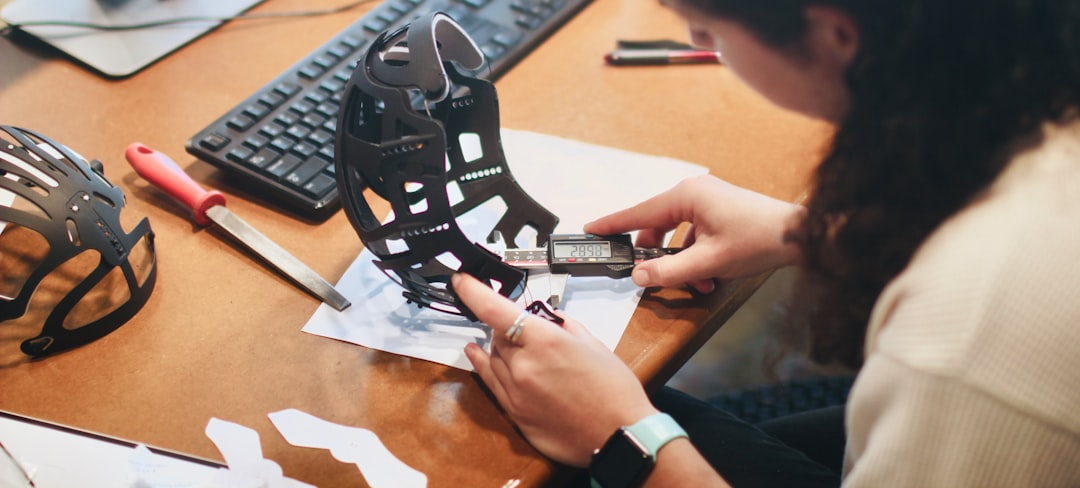 A quality control engineer inspecting a machined part with calipers