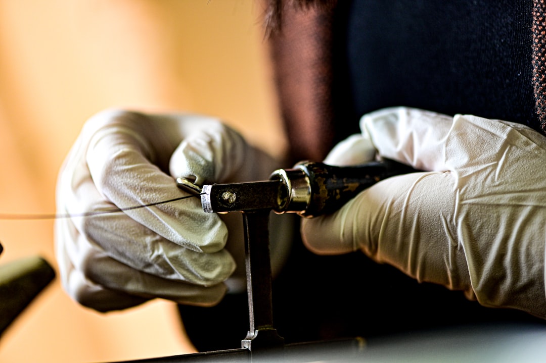 Technician wrapping a hardline connector with weather-proofing tape