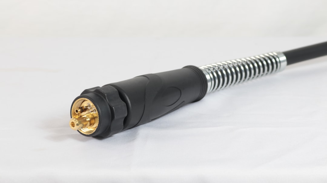 A PAL Male to F-Type antenna cable lying coiled on a white background