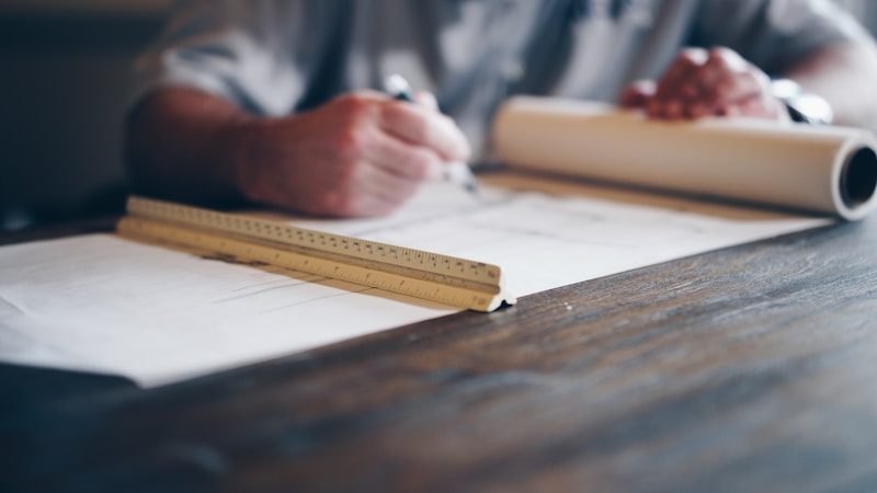 Engineering drawing blueprint specifying dowel pin holes and GD&T positional tolerances