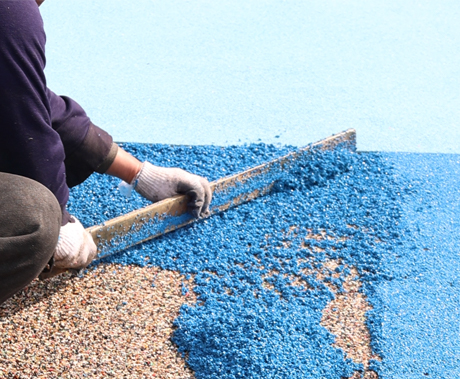 An installer is paving EPDM granules with hands