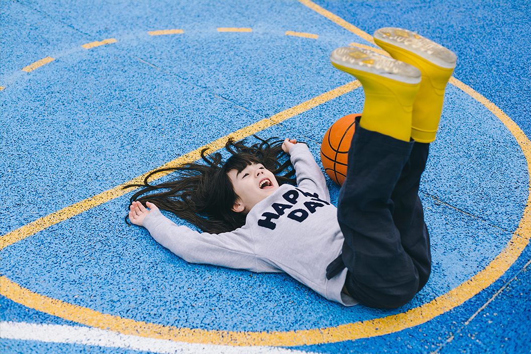 A girl playing on the EPDM granules sports field