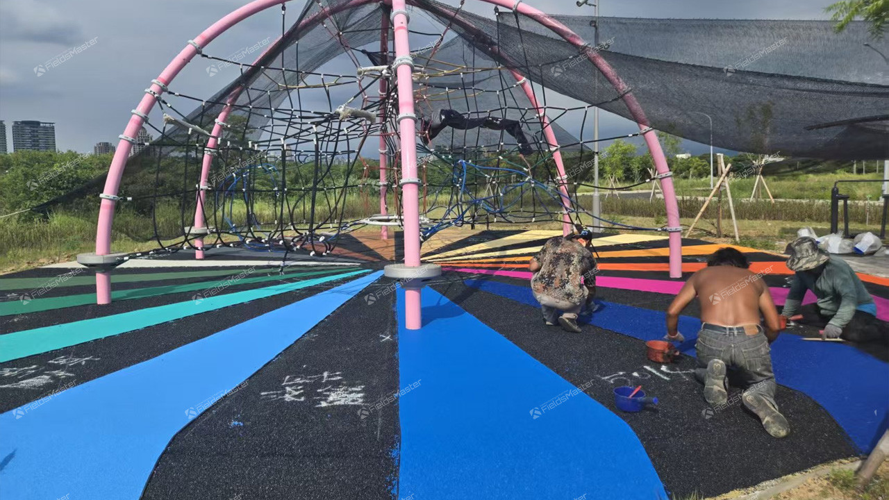 Jack Wu supervising EPDM installation process for FieldsMaster playground project