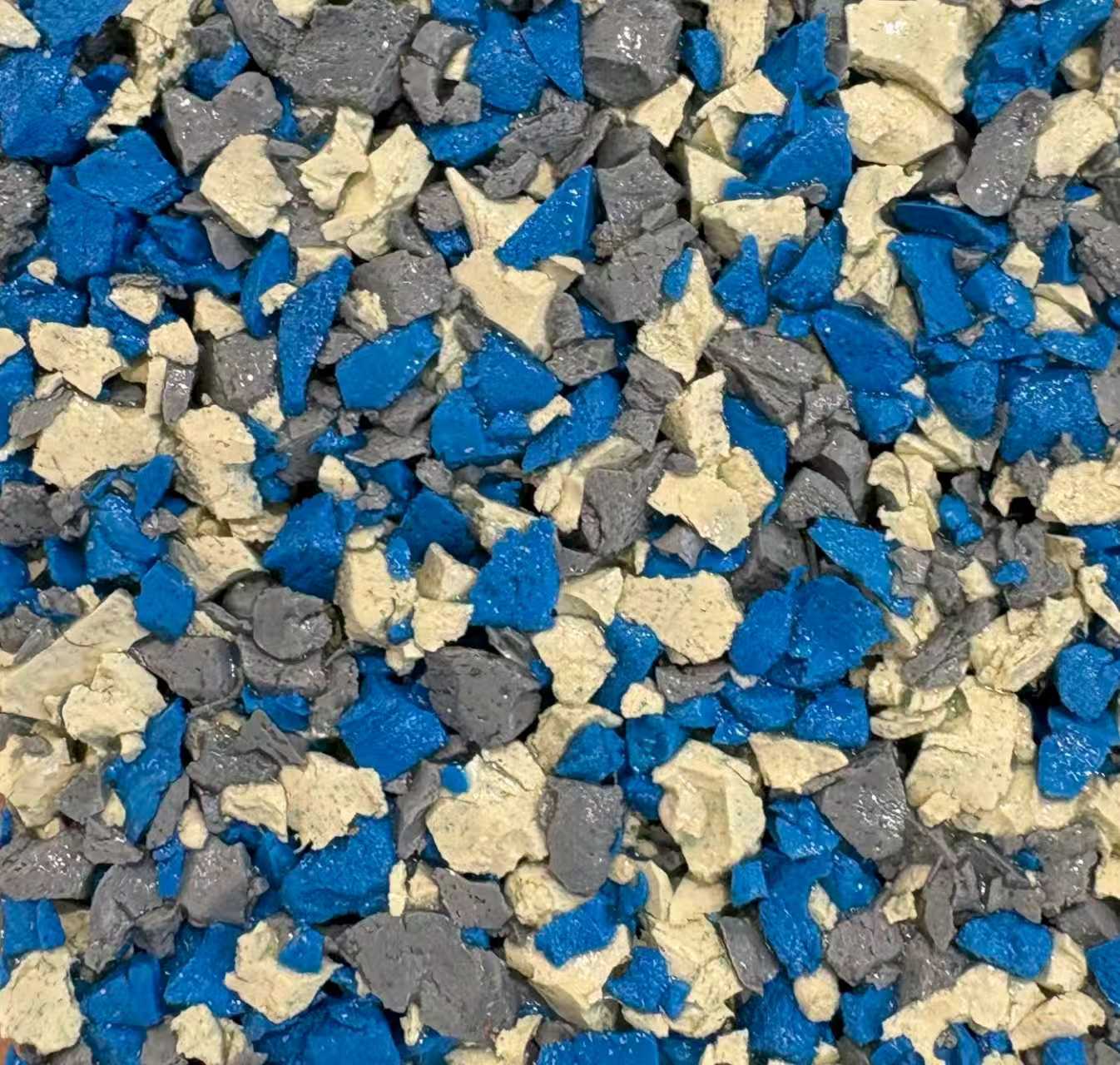 A vibrant, high-energy dopamine-colored playground surface featuring custom EPDM color granules