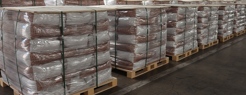 A clean and organized warehouse for EPDM granules with neatly stacked and labeled bags.