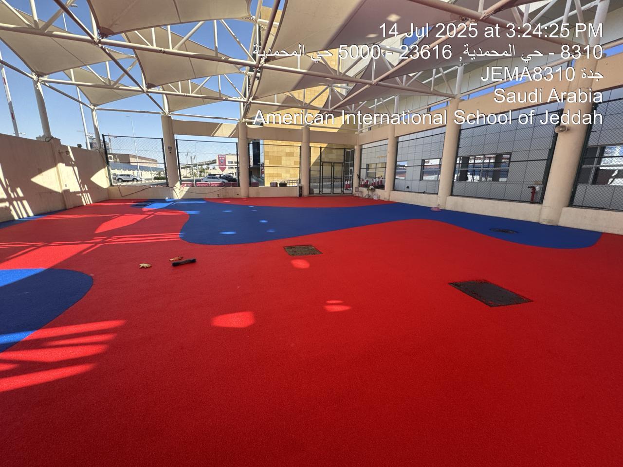 Aerial view of the seamless red and blue EPDM playground surfacing at an American school in Saudi Arabia