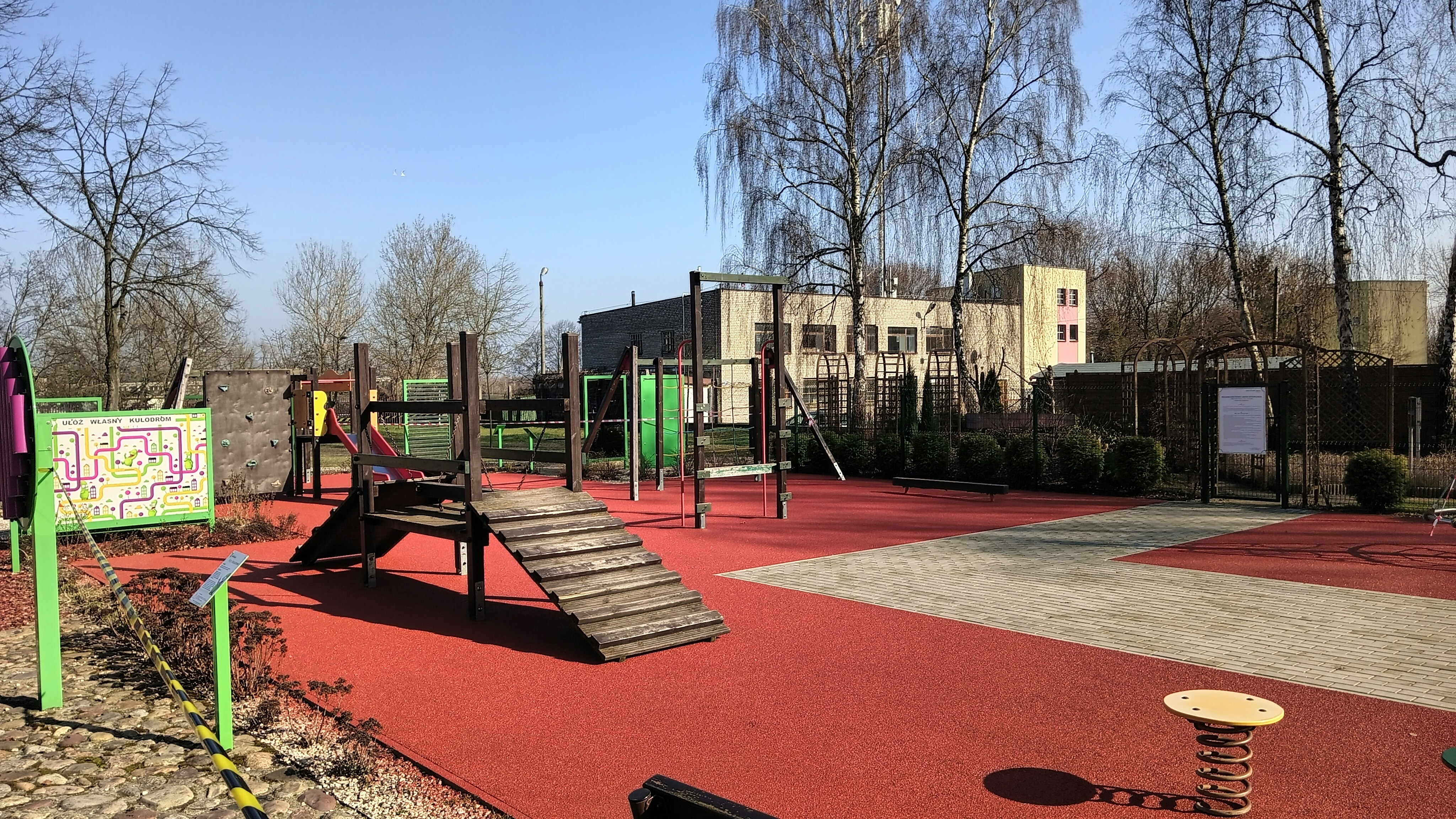 A vibrant school playground with colorful EPDM rubber surfacing in different zones