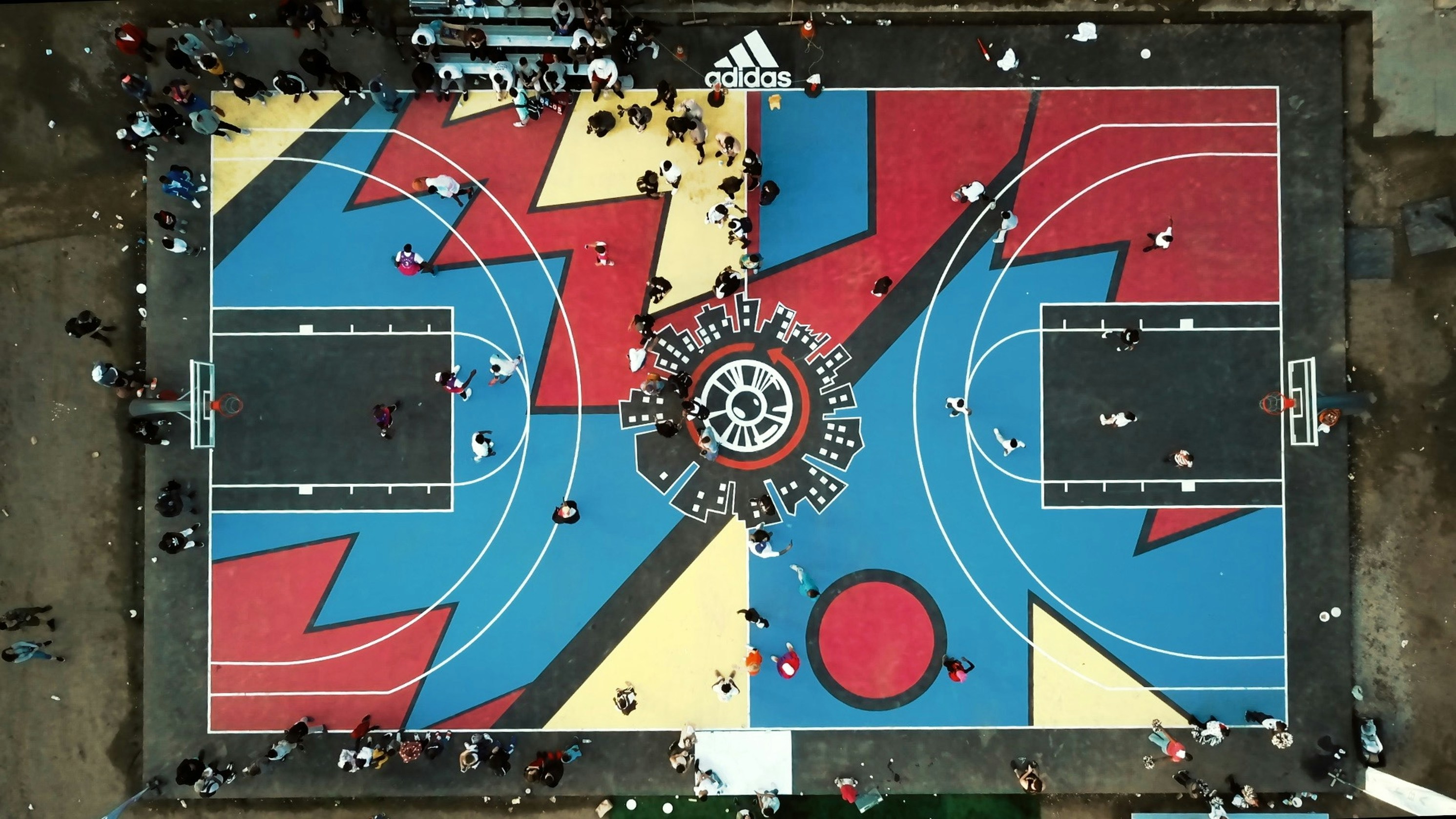 A vibrant, multi-colored playground surface with inlaid graphics of animals and geometric shapes made from EPDM granules.