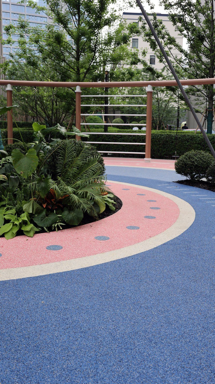 Curved EPDM path integrated with planting in a residential landscape