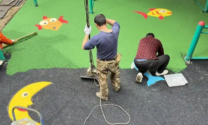 EPDM granule surface being installed on site by an installation crew